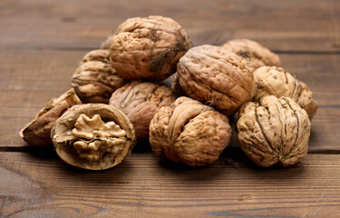 walnut on brown wooden table, close up