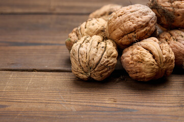 walnut on brown wooden table, close up