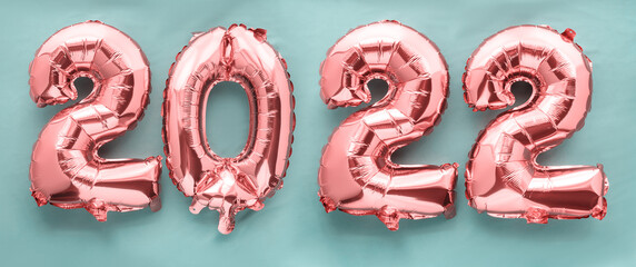 2022 new year pink foil balloon numbers on green background