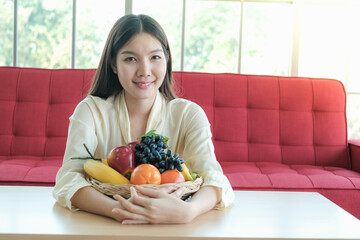 Professional nutritionist asia woman holding fresh fruit in clinic room