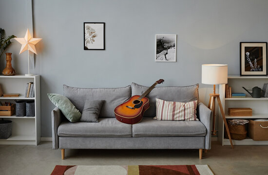 Background Image Of Teenage Boys Room With Acoustic Guitar On Cozy Blue Sofa, Copy Space