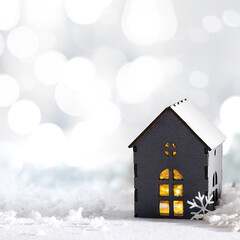 Naklejka premium Christmas background with copy space. Decorative gray house on a white snowy background.