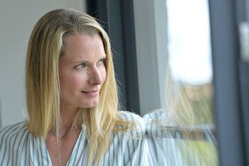 Portrait of beautiful 40-year-old blond woman with blue eyes