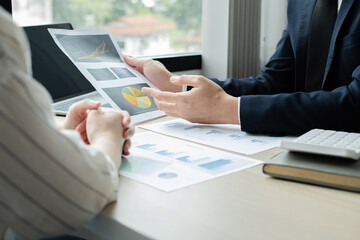 Two business leaders talk about charts, financial graphs showing results are analyzing and calculating planning strategies, business success building processes