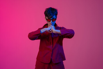 Mature european woman wearing sunglasses holding hands together