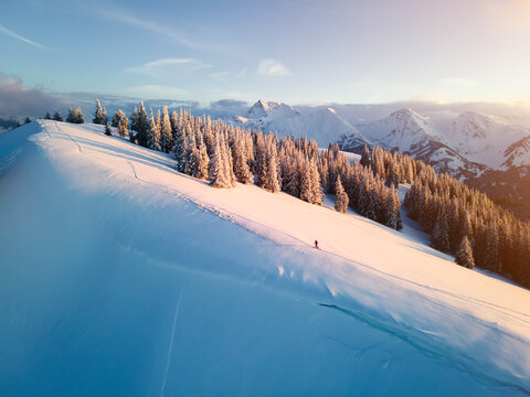 Woman skiing on snow covered mountain at sunrise, Schonkahler, Tyrol, Austria