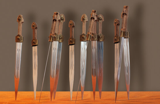 Group of shiny daggers with wooden handles