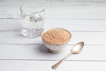 Psyllium husk in a white plate, a superfood prebiotic fiber for gut health
