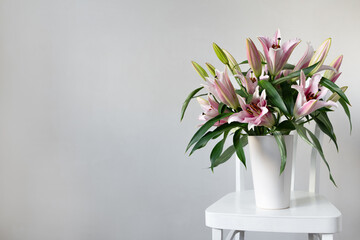 Pink lilies on a white background. Tea drinking. Flowers for the background.