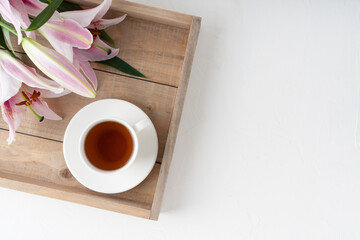 Pink lilies on a white background. Tea drinking. Flowers for the background.