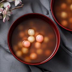 Red and white tangyuan with syrup soup.