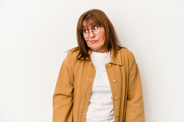 Middle age caucasian woman isolated on white background shrugs shoulders and open eyes confused.