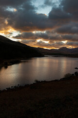 Obraz premium Llynnau Mymbyr at sunset with clouds reflected on the water. Part of the Snowdonia National Park in Wales