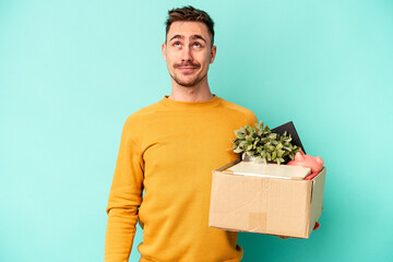 Young caucasian man making a move isolated on blue background dreaming of achieving goals and...