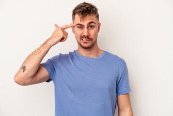 Young caucasian man isolated on white background making up plan in mind, setting up an idea.