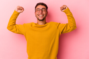 Young caucasian man with tattoos isolated on yellow background  celebrating a victory, passion and...