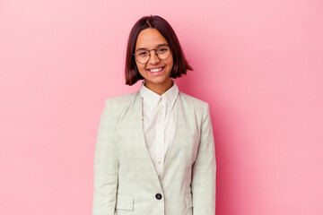 Young mixed race woman wearing a green suit isolated on pink background happy, smiling and cheerful.