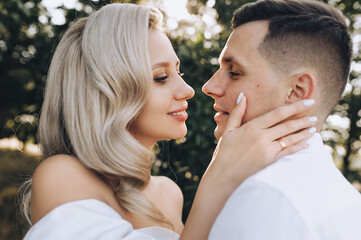 Fototapeta premium Wedding photo, close-up portrait of newlyweds faces profile in nature.