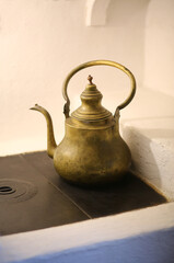 Vintage metal copper kettle standing on the stove