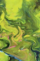 Fototapeta na wymiar Abstract background of yellow-green marble. Multicolored spots of acrylic paint, freely flowing and creating an interesting pattern. Bright color. Background for the cover of a book, laptop.