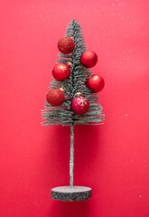 Christmas tree and decoration balls on red color background. Xmas baubles red and gold color.