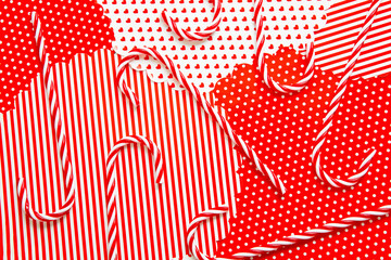 Xmas candy canes on red white festive background, Christmas traditional striped candies pattern