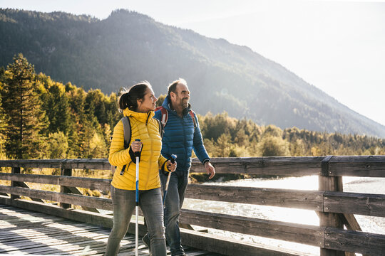 Smiling mature couple hiking on sunny day
