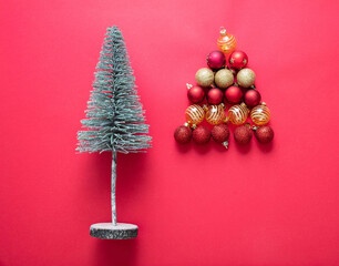 Christmas tree and decoration balls on red color background. Xmas baubles red and gold color.