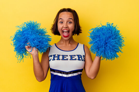 Young cheerleader woman isolated on yellow background