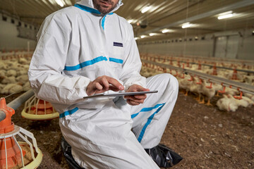 Man using tablet computer in production factory