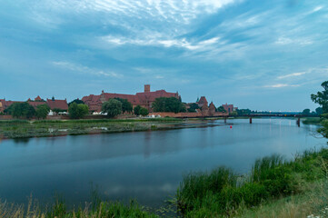 Evening view on Teutonic Castle on Nogat river in Malbork.