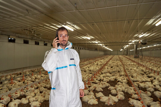 Man talking on smart phone in factory