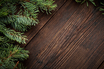 Creative layout made of winter evergreen tree branches over rustic wooden background. Flat lay. Nature Christmas concept. New Year concept.