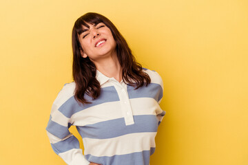 Young caucasian woman isolated on yellow background suffering a back pain.