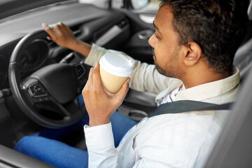 transport, vehicle and people concept - tired indian man or driver with takeaway coffee cup driving car