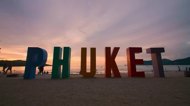 Phuket sign multi color on beach at Patong beach , Phuket Thailand. The beach with PHUKET sign and tourists on the beach