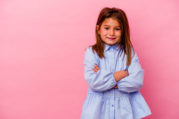 Little caucasian girl isolated on pink background  smiling confident with crossed arms.
