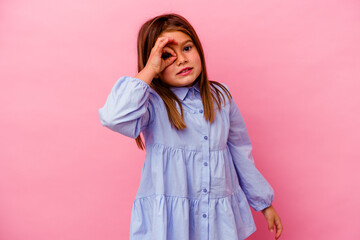 Little caucasian girl isolated on pink background  excited keeping ok gesture on eye.