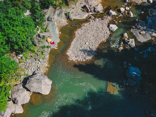 aerial view of people resting at mountain river beach