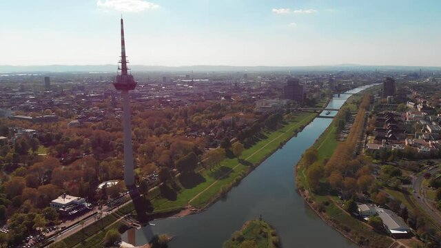 Top view of the embankment of the Neckar River. Bridges, TV tower, green grass and trees. Hospital, tram lines. Mannheim. Germany.