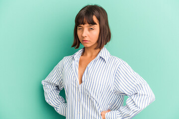 Young mixed race woman isolated on blue frowning face in displeasure, keeps arms folded.