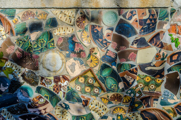 Mosaic of broken ceramics painted by hand.