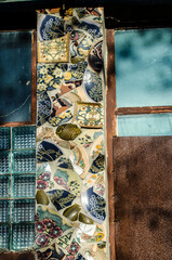 Mosaic of broken ceramics painted by hand.