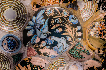 Mosaic of broken ceramics painted by hand.