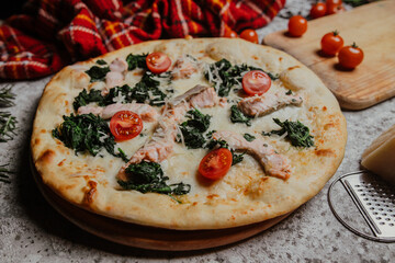 pizza with salmon and tomatoes
