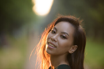 Naklejka premium Young asian woman at the park