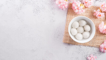 Top view of Tang Yuan(sweet dumplings balls) on stone background. Traditional cuisine for lantern festival, Mid-autumn, Dongzhi (winter solstice festival) and Chinese new year. - obrazy, fototapety, plakaty