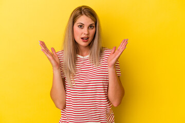 Young russian woman isolated on yellow background surprised and shocked.