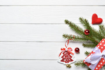 Fototapeta na wymiar A fir branch and festive decorations. Flat layout
