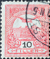 HUNGARY - CIRCA 1900: A post stamp printed in Hungary showing a Mythical Bird Turul flying over Crown of St. Stephen. red